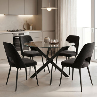 Модерен и луксузен трпезариски лоунџ сет Dining Room со тркалезна маса од калено проѕирно стакло Antoro и четири естетски црни столови Rankic со стабилна метална архитектура